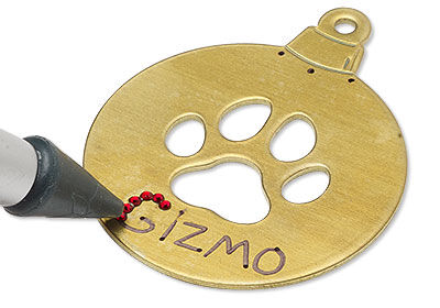 Adding rhinestones to the word "Gizmo"